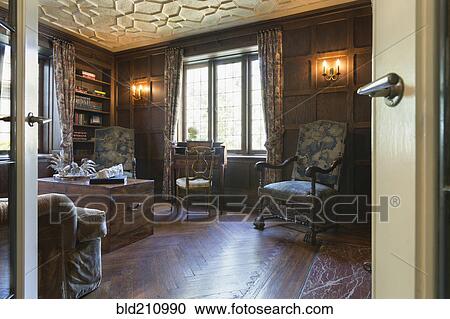 Stock Image - Chairs and trunk in ornate study. Fotosearch