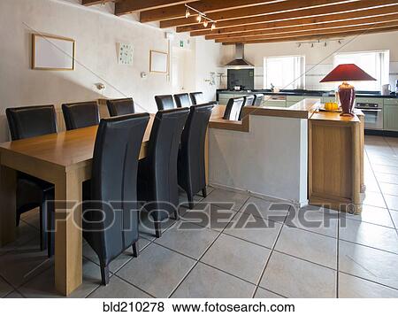 Chairs at empty kitchen table View Large Photo Image Stock Photo - Chairs at empty kitchen table. Fotosearch