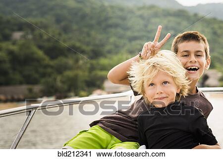Stock Image - Children playing on deck of yacht. Fotosearch
