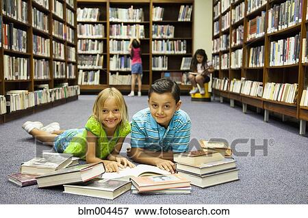 Children reading books on library floor View Large Photo Image Stock Photo - Children reading books on library floor. Fotosearch