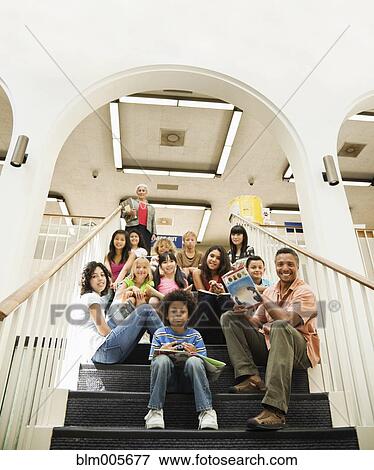 Children sitting on library staircase View Large Photo Image Stock Photo - Children sitting on library staircase. Fotosearch