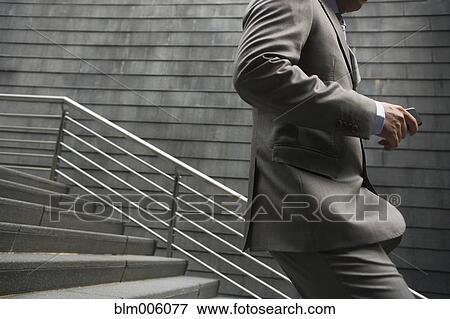 Chinese businessman running down stairs View Large Photo Image Stock Photo - Chinese businessman running down stairs. Fotosearch