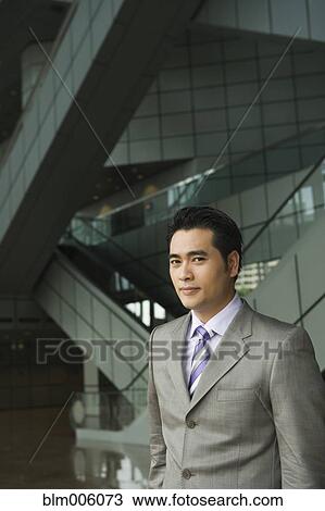 Stock Image - Chinese businessman smiling. Fotosearch