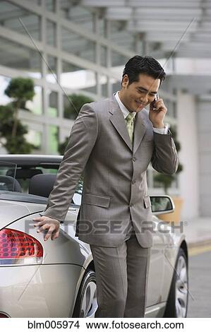 Chinese businessman talking on cell phone View Large Photo Image Picture - Chinese businessman talking on cell phone . Fotosearch