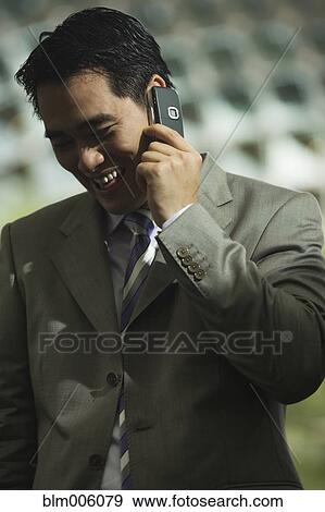 Chinese businessman talking on cell phone View Large Photo Image Stock Photo - Chinese businessman talking on cell phone. Fotosearch
