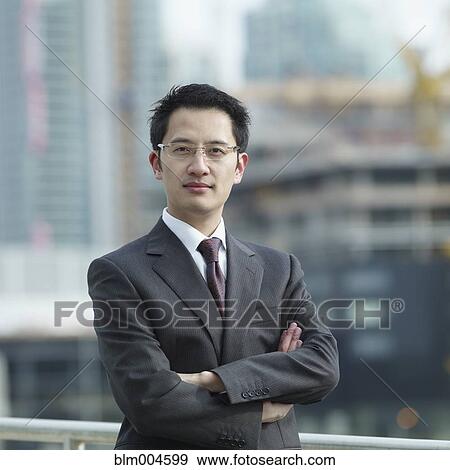 Chinese businessman with arms crossed View Large Photo Image Stock Photo - Chinese businessman with arms crossed. Fotosearch