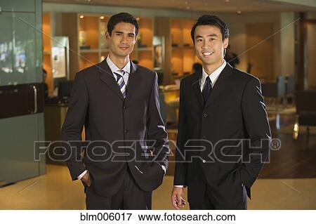 Stock Photo - Chinese businessmen standing in bar. Fotosearch