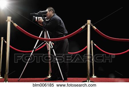 Chinese cameraman with camera on red carpet View Large Photo Image Stock Photography - Chinese cameraman with camera on red carpet. Fotosearch