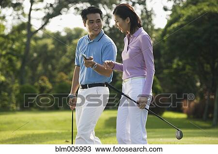 Chinese couple playing golf View Large Photo Image Stock Image - Chinese couple playing golf. Fotosearch