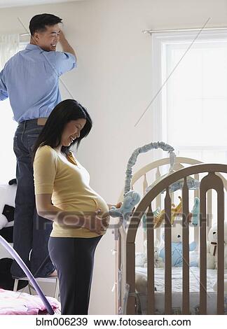 Stock Photo - Chinese couple preparing nursery. Fotosearch