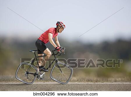 Stock Photograph - Chinese cyclist riding bicycle with square wheels. Fotosearch