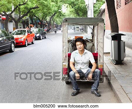 Chinese man sitting on cart View Large Photo Image Stock Image - Chinese man sitting on cart. Fotosearch