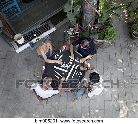 Stock Image - Chinese men playing game. Fotosearch