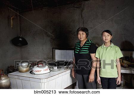 Chinese mother and daughter in kitchen View Large Photo Image Stock Image - Chinese mother and daughter in kitchen. Fotosearch