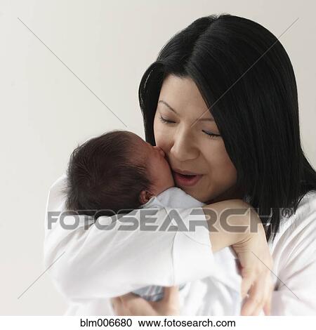 Chinese mother hugging newborn baby girl View Large Photo Image Stock Image - Chinese mother hugging newborn baby girl. Fotosearch