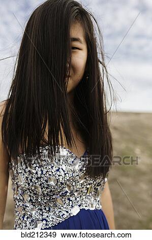 Chinese teenage girl wearing gown in rural field View Large Photo Image Stock Photo - Chinese teenage girl wearing gown in rural field. Fotosearch