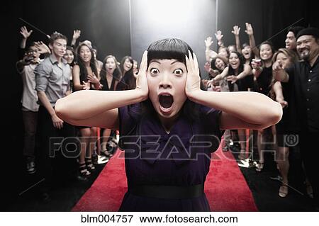 Stock Photo - Chinese woman screaming on red carpet. Fotosearch
