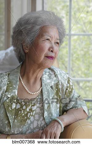 Chinese woman sitting in chair View Large Photo Image Stock Photo - Chinese woman sitting in chair. Fotosearch