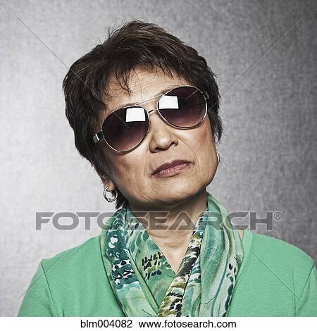 Close up of Asian woman wearing sunglasses View Large Photo Image Stock Image - Close up of Asian woman wearing sunglasses. Fotosearch