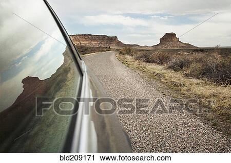 Stock Image - Close up of car window driving through desert landscape, Chaco Canyon, New Mexico, United States. Fotosearch