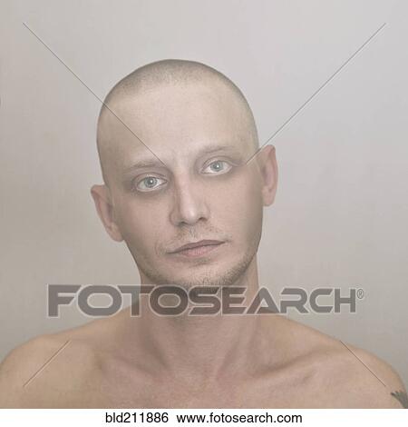 Stock Photograph - Close up of Caucasian man with shaved-head. Fotosearch