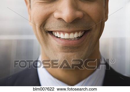 Stock Image - Close up of mixed race businessman smiling. Fotosearch