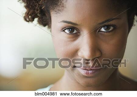 Stock Image - Close up of smiling African woman. Fotosearch
