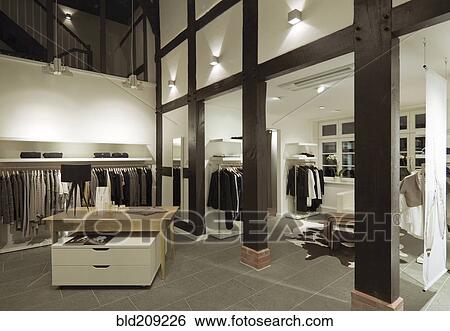 Stock Photograph - Clothes for sale in modern store. Fotosearch