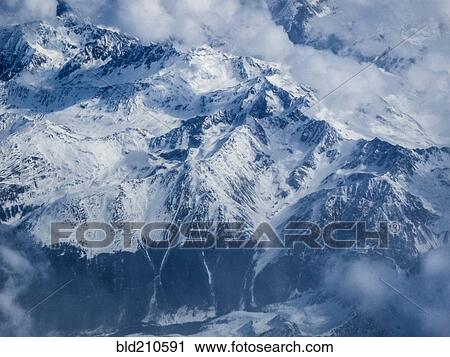 Clouds and snow covered mountains, Switzerland View Large Photo Image Stock Image - Clouds and snow covered mountains, Switzerland. Fotosearch