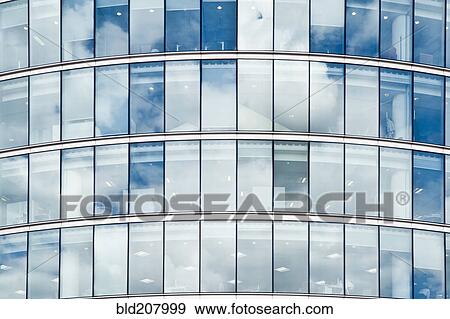 Stock Photo - Clouds Reflecting Off an Office Building. Fotosearch