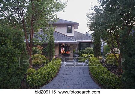 Stock Photography - Cobblestone driveway to house. Fotosearch