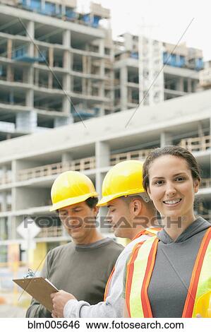 Construction workers on construction site View Large Photo Image Stock Photograph - Construction workers on construction site. Fotosearch