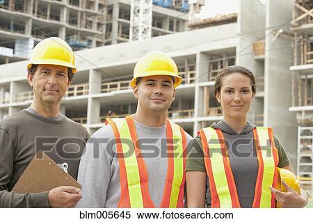 Stock Photography - Construction workers on construction site. Fotosearch