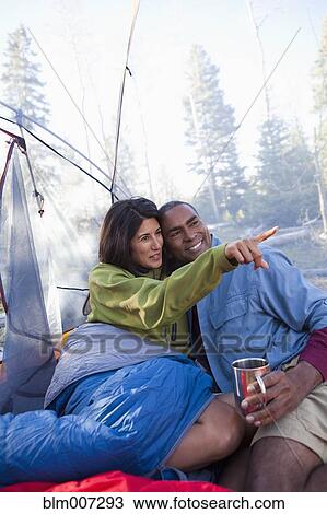 Couple camping and cuddling in tent View Large Photo Image Stock Image - Couple camping and cuddling in tent. Fotosearch