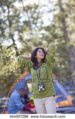 Couple camping with woman stretching View Large Photo Image Stock Photo - Couple camping with woman stretching. Fotosearch