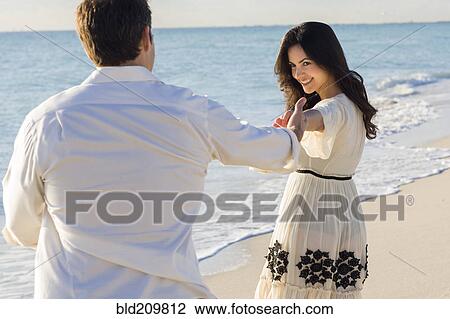 Stock Image - Couple dancing on beach. Fotosearch