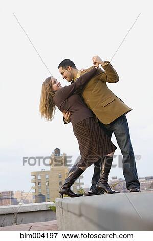 Stock Photo - Couple dancing on rooftop. Fotosearch