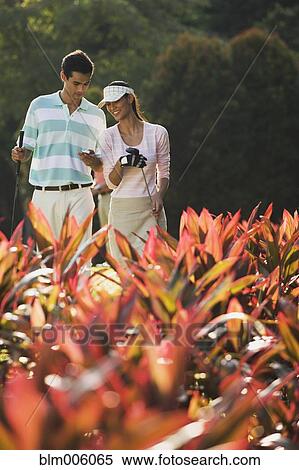 Couple golfing together View Large Photo Image Stock Photography - Couple golfing together. Fotosearch
