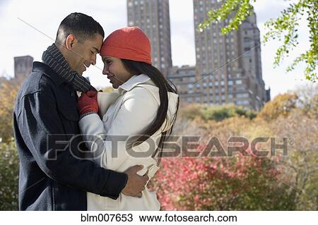 Couple hugging in park View Large Photo Image Stock Image - Couple hugging in park. Fotosearch