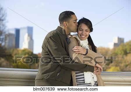 Stock Photo - Couple hugging in park. Fotosearch