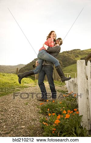 Couple hugging in rural landscape View Large Photo Image Stock Image - Couple hugging in rural landscape. Fotosearch