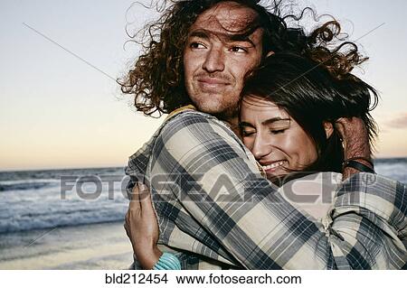Picture - Couple hugging on beach. Fotosearch