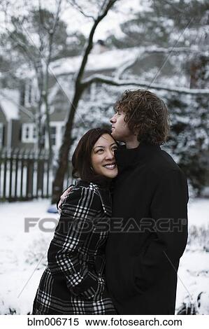 Couple hugging outdoors in snow View Large Photo Image Stock Photography - Couple hugging outdoors in snow. Fotosearch
