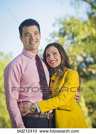Couple hugging outdoors View Large Photo Image Stock Image - Couple hugging outdoors. Fotosearch