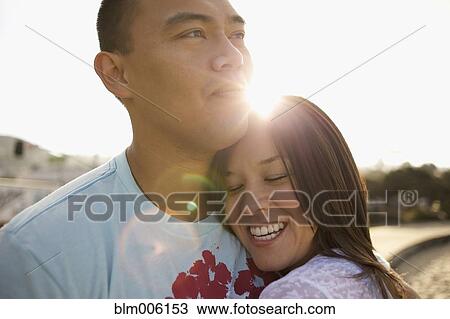 Couple hugging outdoors View Large Photo Image Stock Image - Couple hugging outdoors. Fotosearch
