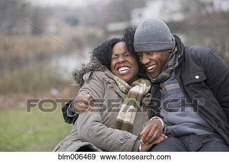 Stock Photo - Couple laughing together outdoors. Fotosearch