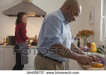 Couple making dinner together View Large Photo Image Stock Photo - Couple making dinner together. Fotosearch