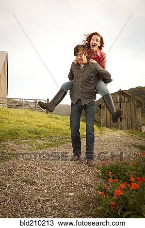 Stock Image - Couple playing in rural landscape. Fotosearch