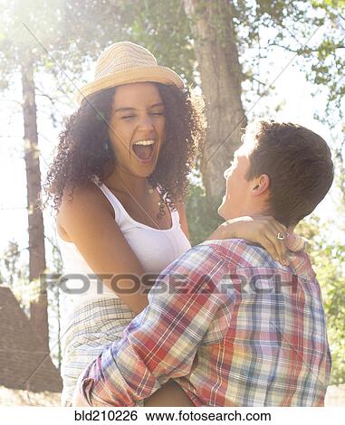 Stock Photograph - Couple playing in woods. Fotosearch