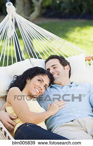 Stock Photo - Couple relaxing in hammock. Fotosearch